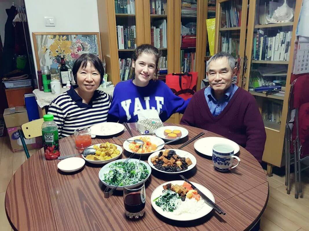 Savannah eating dinner with her Homestay Family