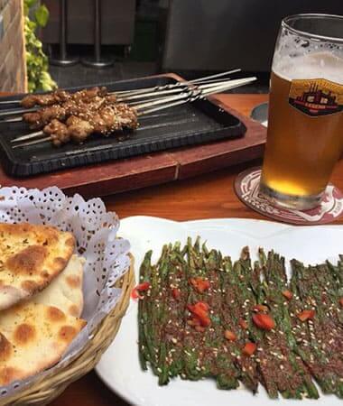 selection of beer and Chinese bar food on a table